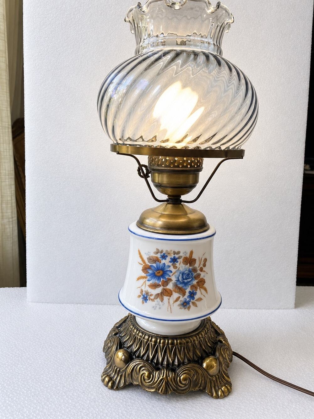 vintage hurricane or parlor table lamp with an ornate brass base milk glass